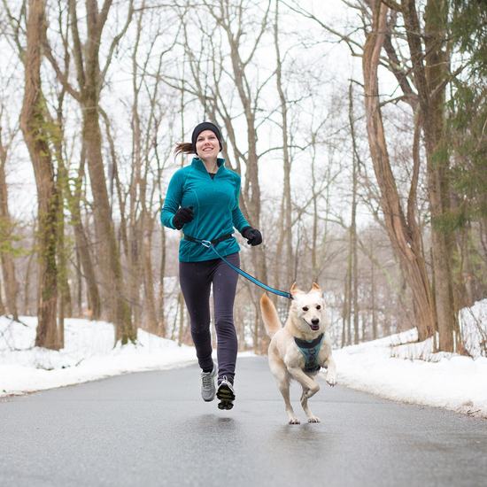 kurgo quantum leash around waist of woman jogging with dog
