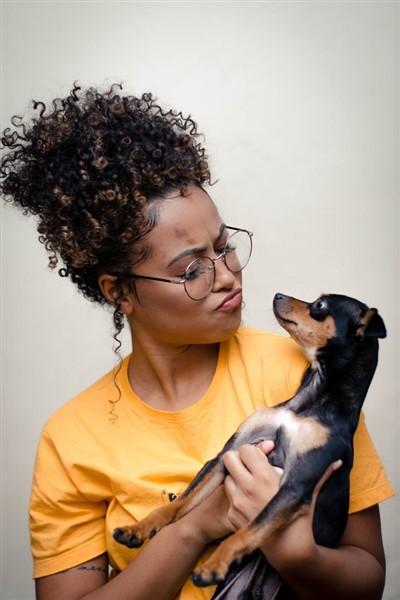 woman wondering how can i deworm my dog naturally by Wallace Chuck
