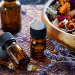 table of essential oils and dried flowers like lavender Are essential oils safe for dogs